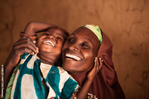 African child smiling with mother